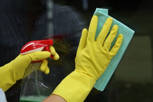 Technician performing steam carpet cleaning in a living room
