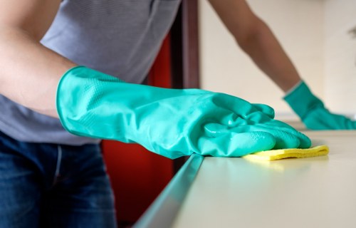Vacuuming curtains to remove dust and allergens